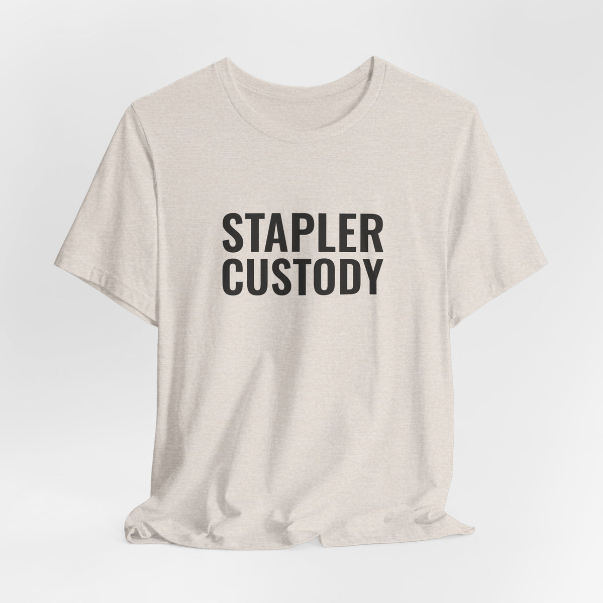 Heather dust “Stapler Custody” tee on a hanger