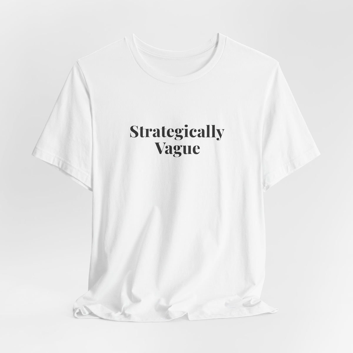 White “Strategically Vague” tee on a hanger