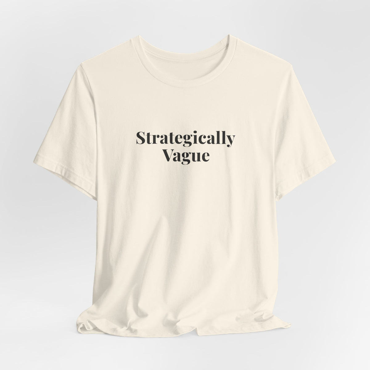 Hanging natural “Strategically Vague” tee, front print