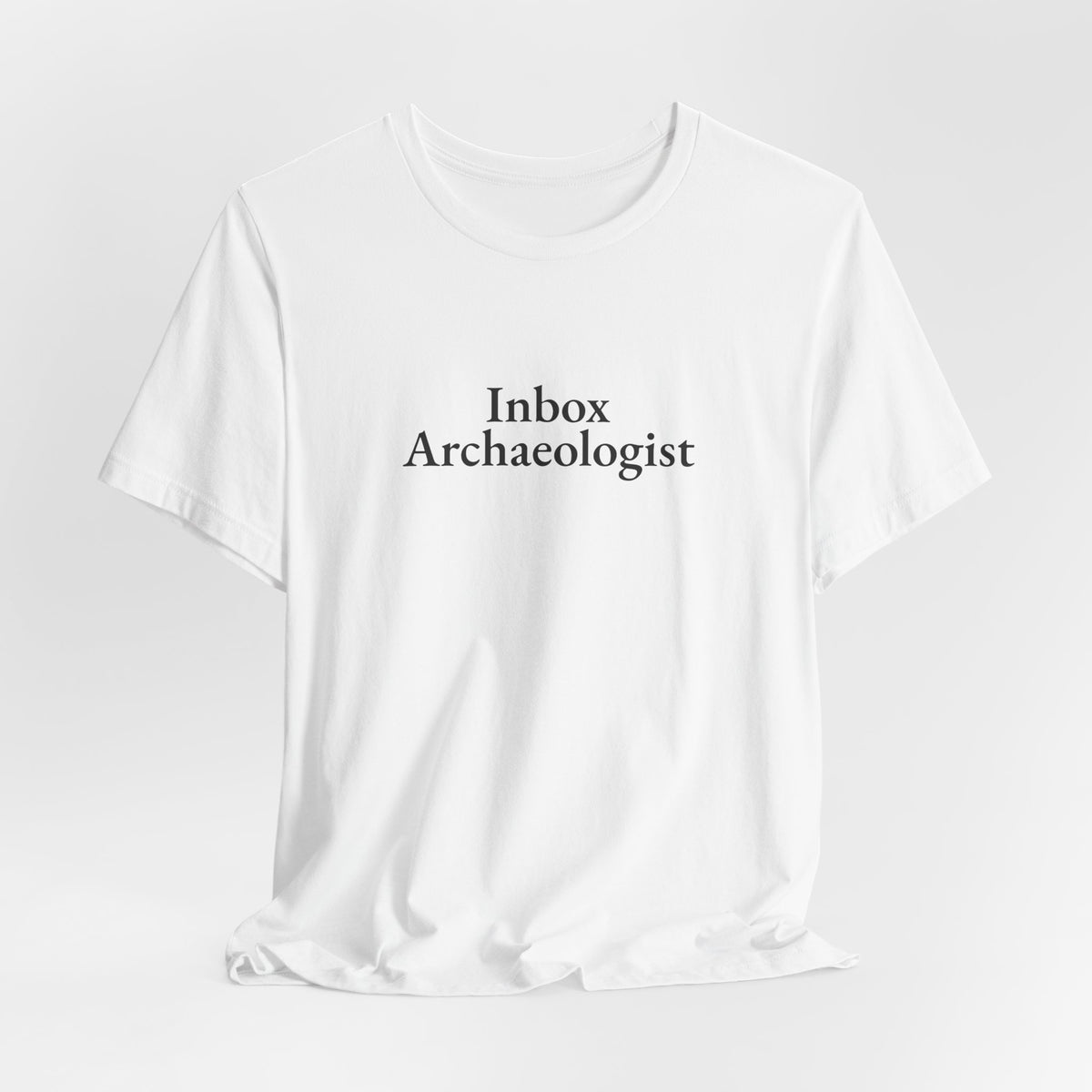 White “Inbox Archaeologist” tee on a hanger