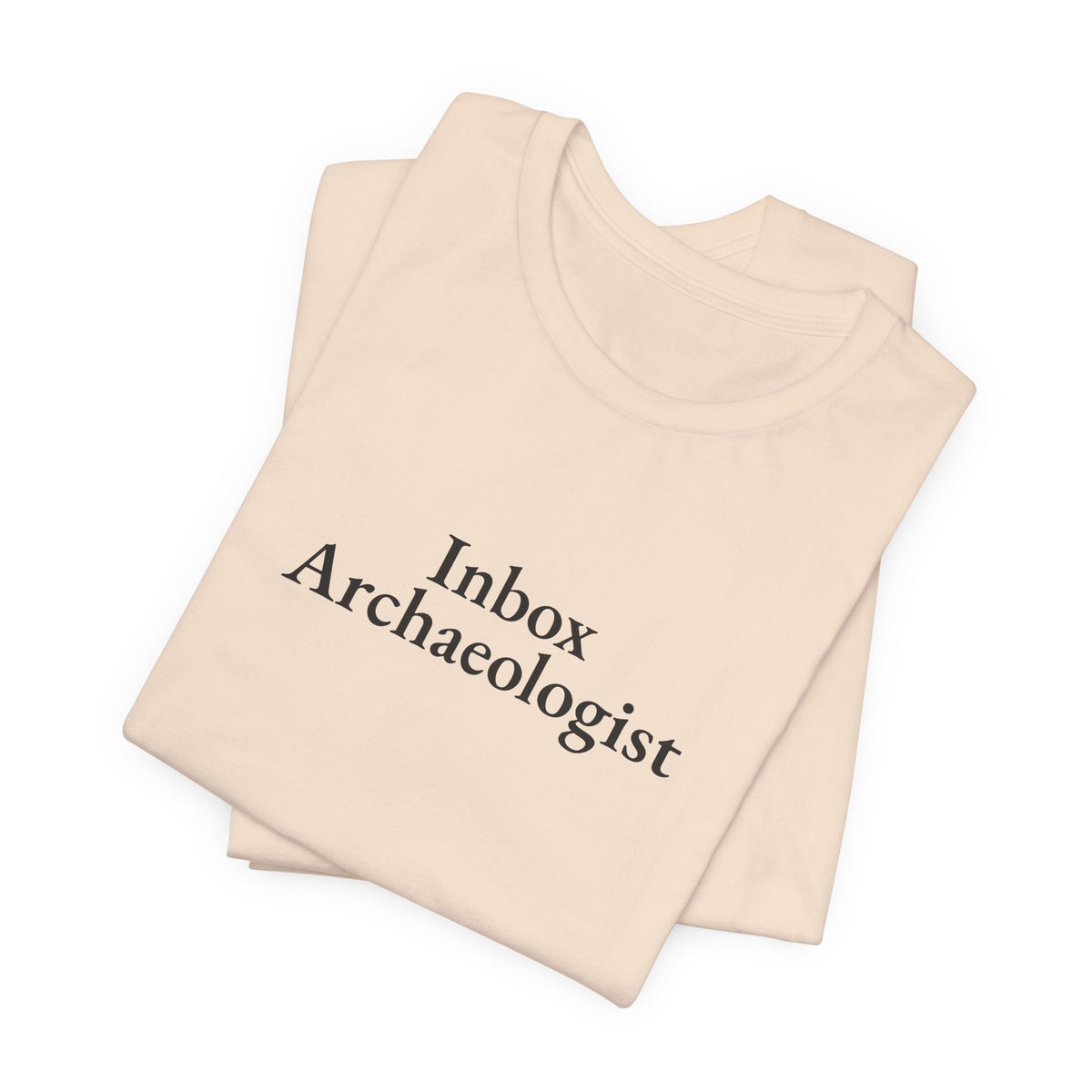Soft cream “Inbox Archaeologist” tee, folded