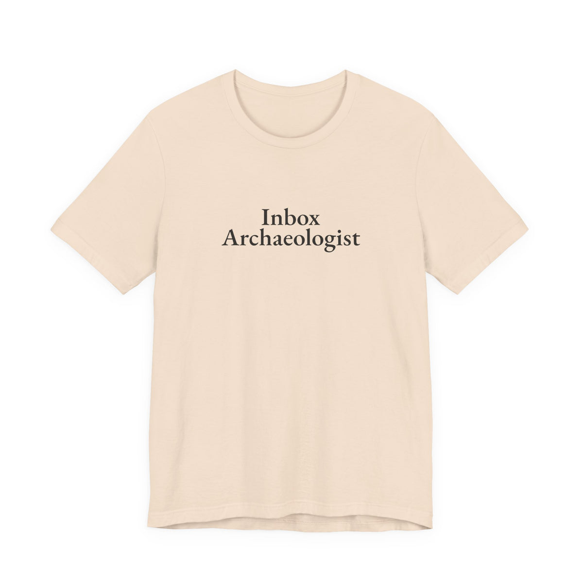 Soft cream tee printed with “Inbox Archaeologist”, front view