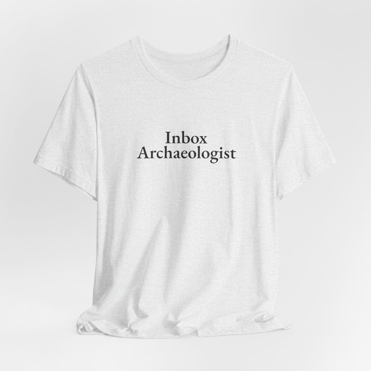 The ash “Inbox Archaeologist” tee hanging on a hanger